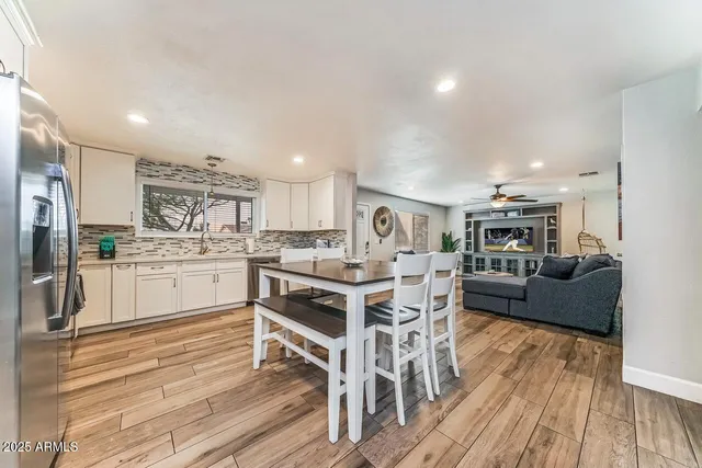 a open kitchen with white cabinets and stainless steel appliances