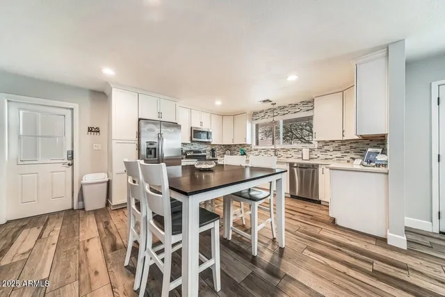 a kitchen with stainless steel appliances kitchen island granite countertop a sink and cabinets