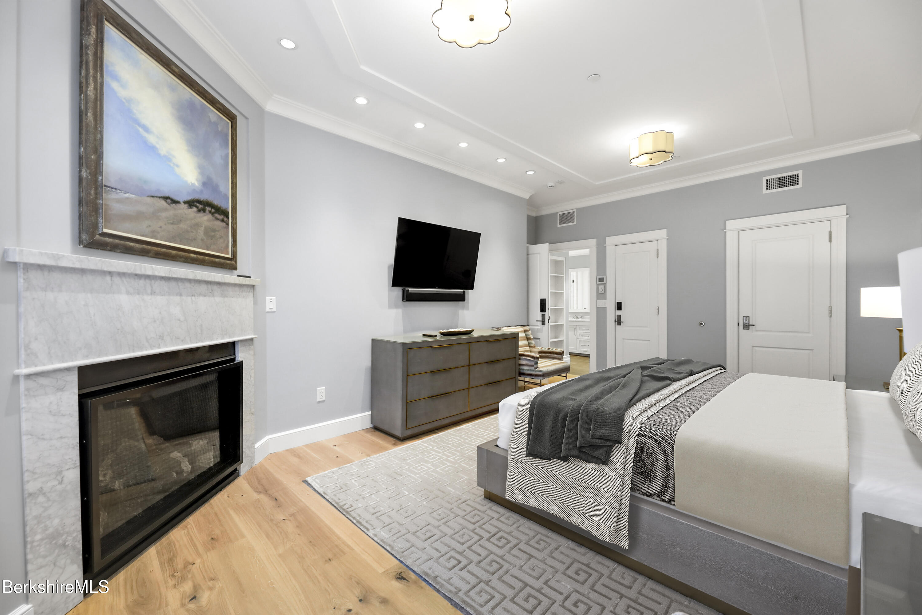 165 Kemble Street, Unit 10 Lenox, MA 01240 - Photo 14 of 24 a spacious bedroom with a bed and a flat screen tv