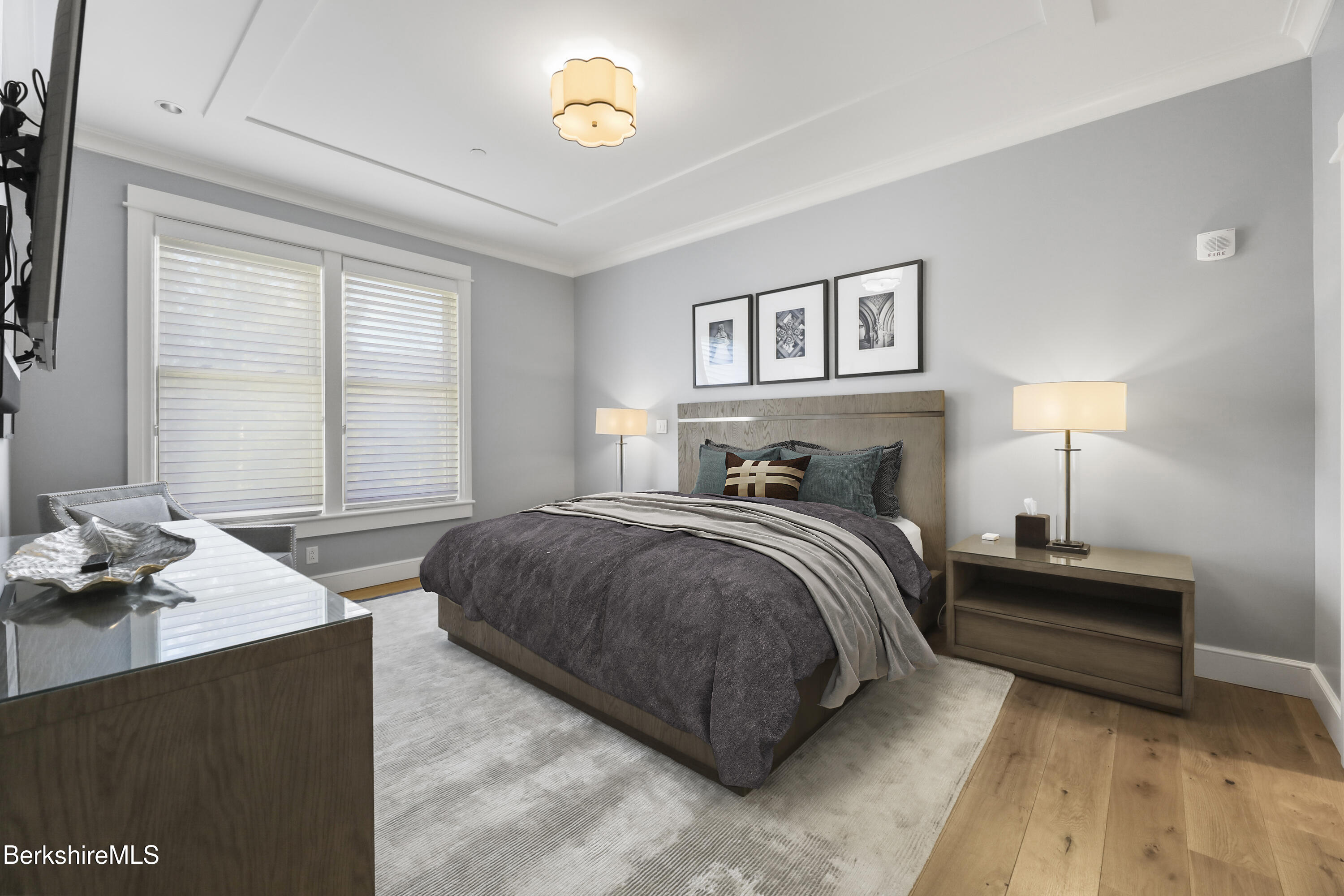 165 Kemble Street, Unit 10 Lenox, MA 01240 - Photo 17 of 24 a bedroom with a bed and wooden floor