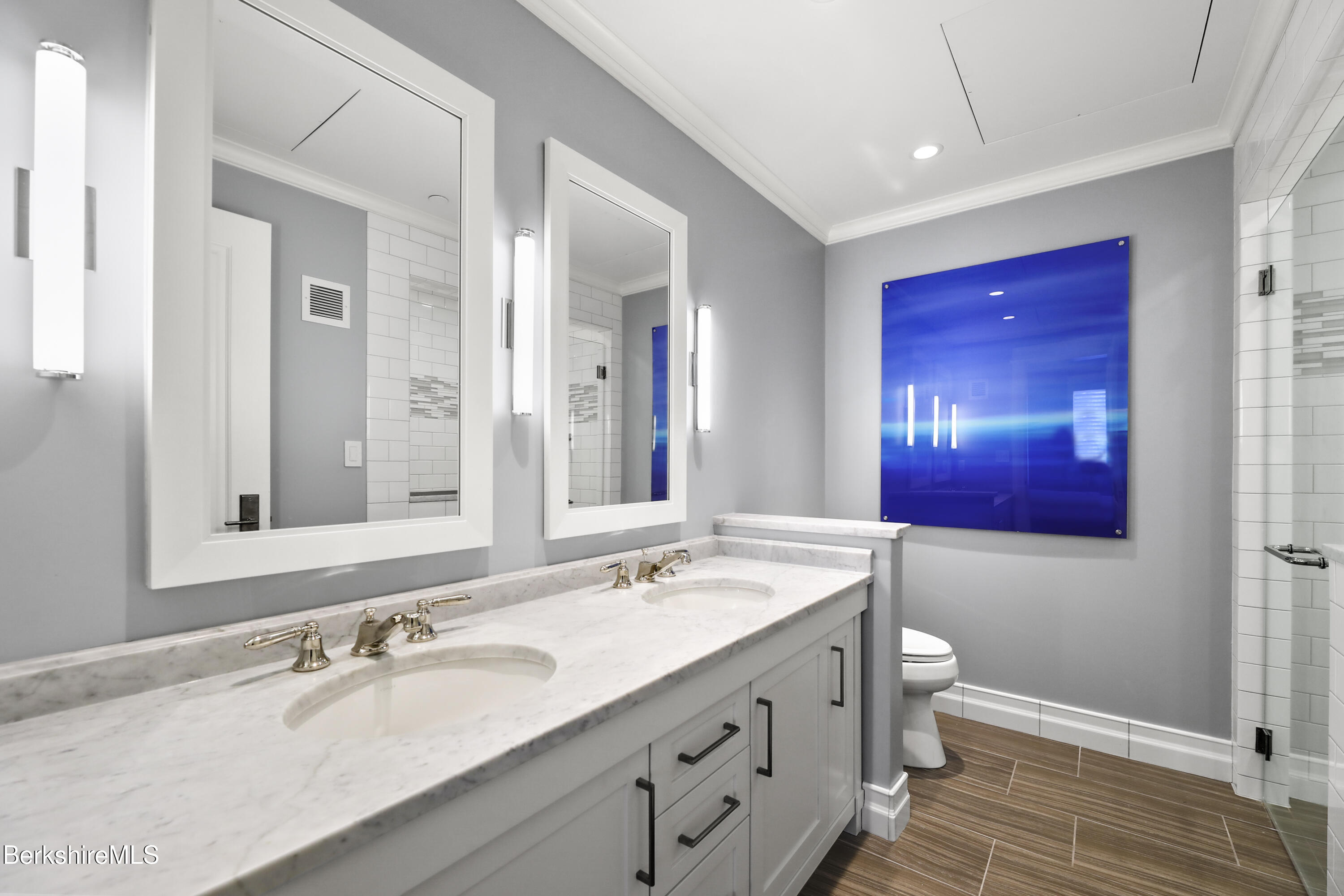 165 Kemble Street, Unit 10 Lenox, MA 01240 - Photo 18 of 24 a bathroom with a granite countertop double vanity sink a mirror and a bathtub