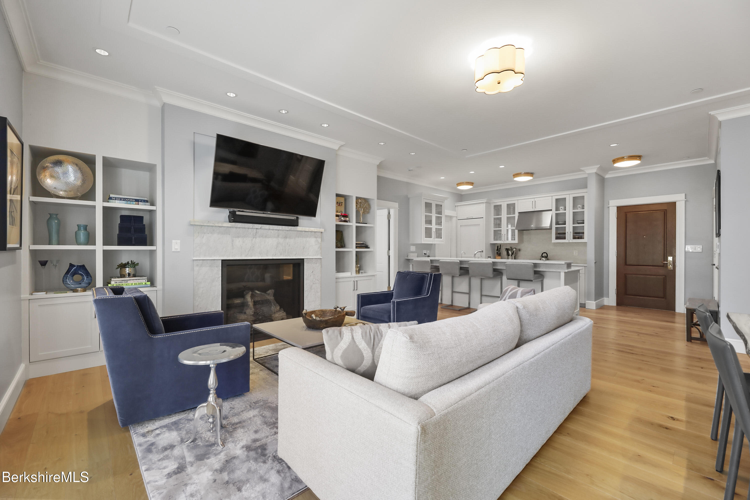 165 Kemble Street, Unit 10 Lenox, MA 01240 - Photo 5 of 24 a living room with furniture fireplace and flat screen tv