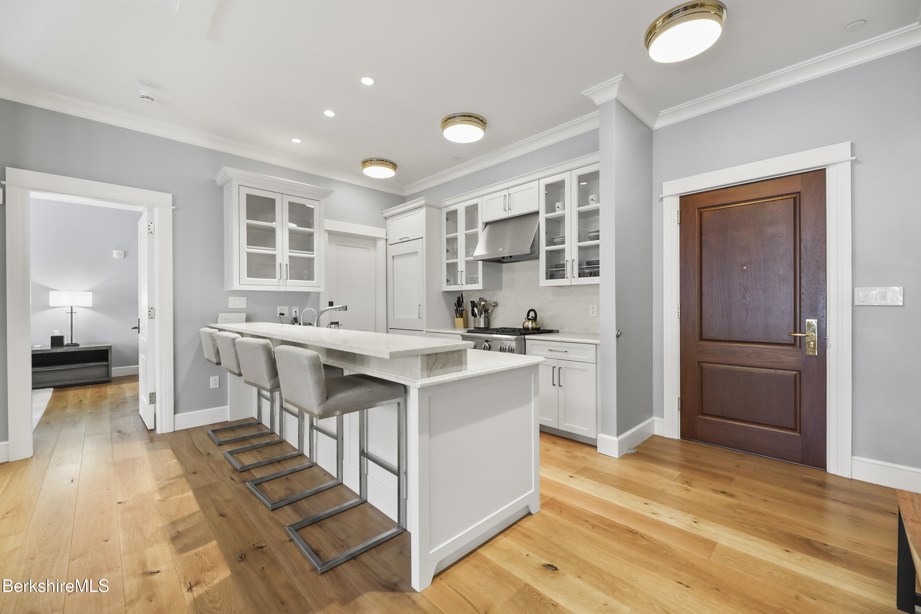 165 Kemble Street, Unit 10 Lenox, MA 01240 - Photo 6 of 24 a kitchen with kitchen island a sink appliances and cabinets