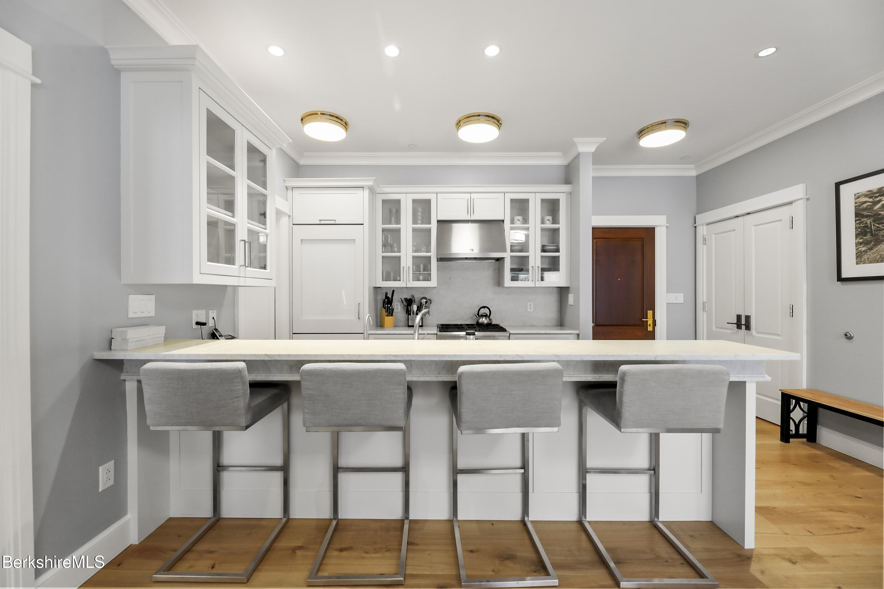 165 Kemble Street, Unit 10 Lenox, MA 01240 - Photo 7 of 24 a kitchen with a sink and chairs