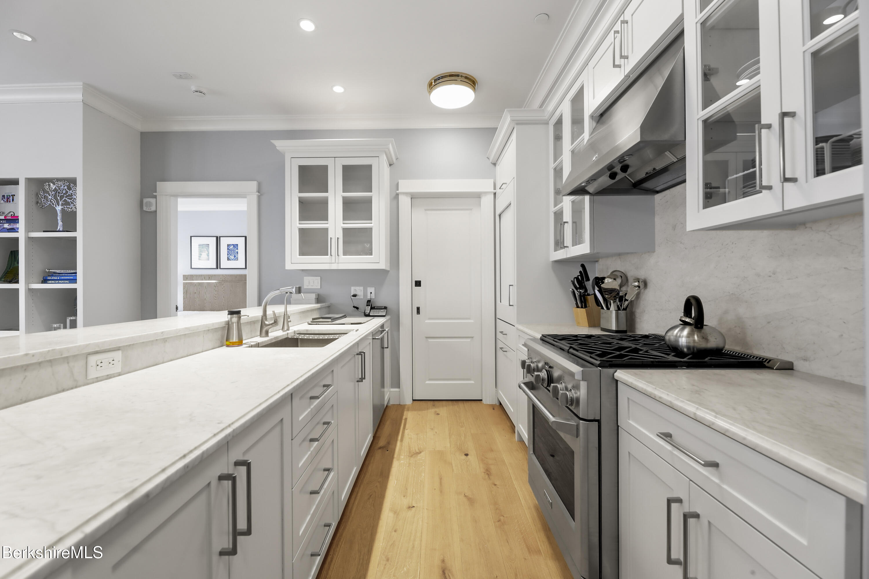 165 Kemble Street, Unit 10 Lenox, MA 01240 - Photo 8 of 24 a kitchen with a sink and cabinets