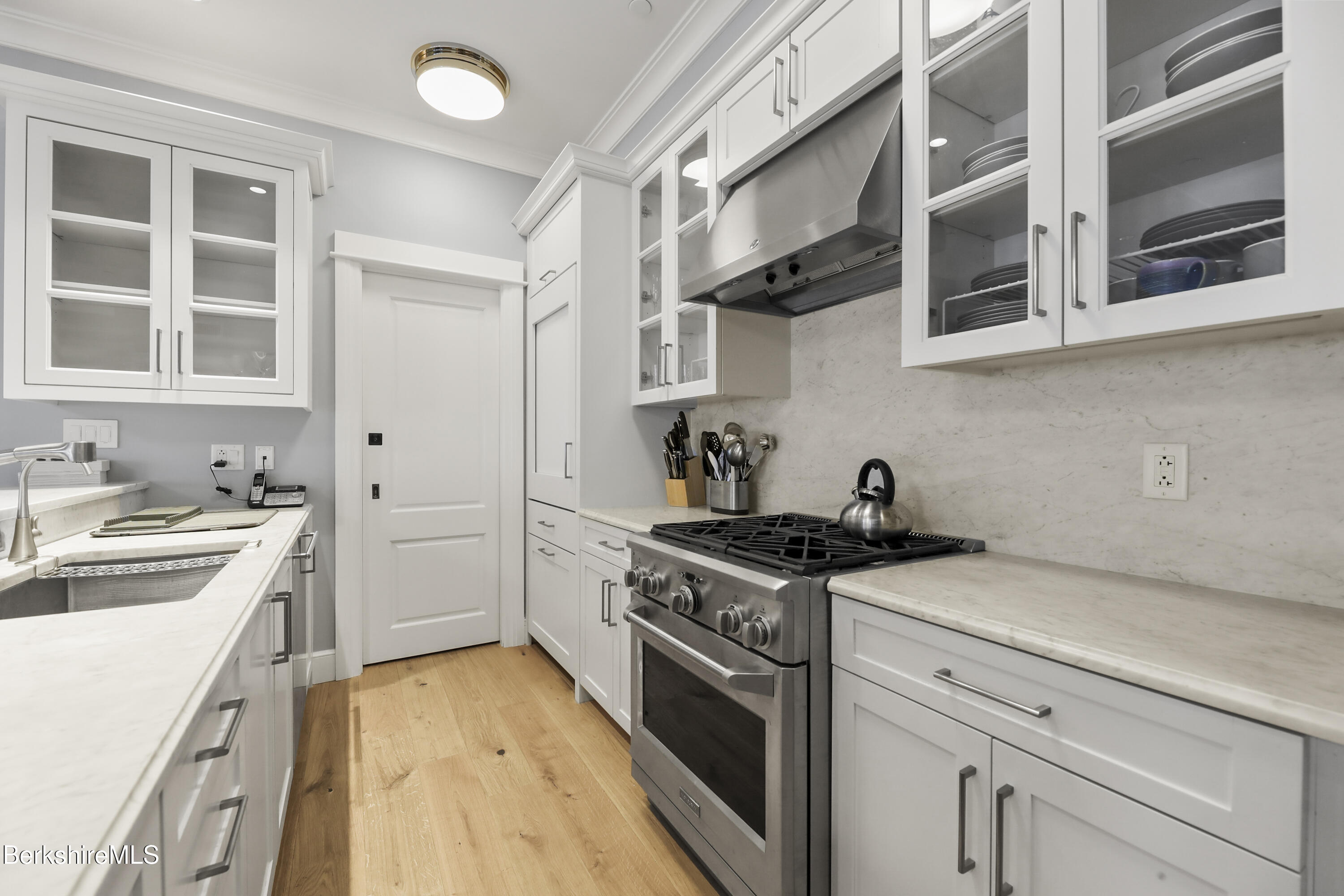 165 Kemble Street, Unit 10 Lenox, MA 01240 - Photo 9 of 24 a kitchen with stainless steel appliances granite countertop a stove and a sink