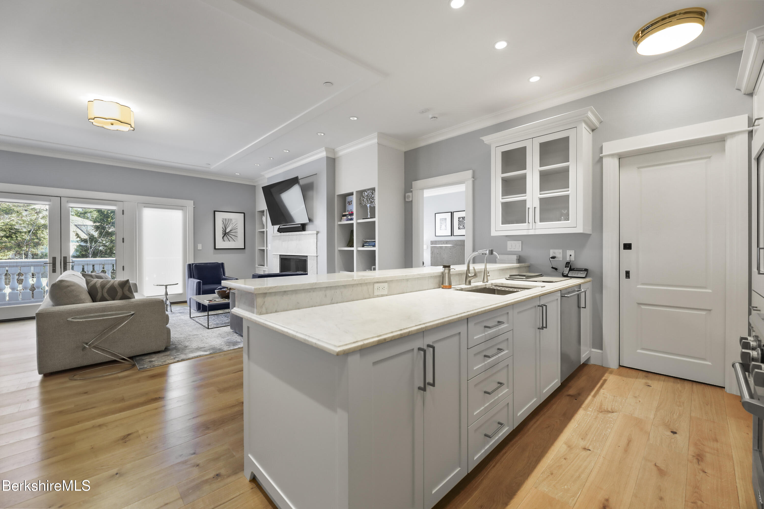 165 Kemble Street, Unit 10 Lenox, MA 01240 - Photo 10 of 24 a large white kitchen with a large window