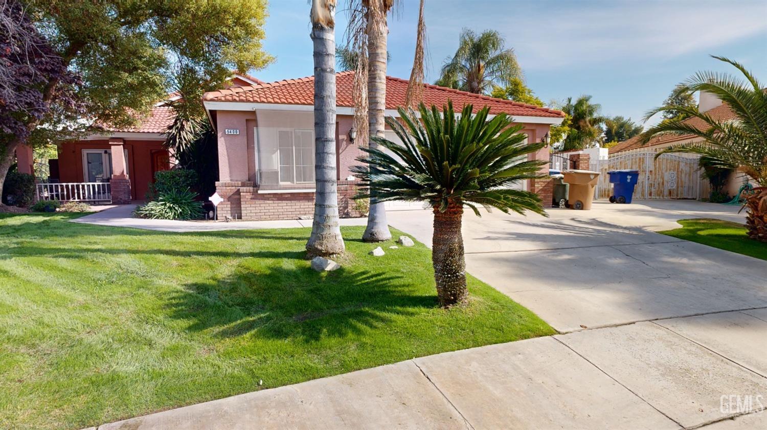 Undisclosed Address Bakersfield, CA 93313 - Photo 1 of 37 a palm plant sitting in front of a house with a yard