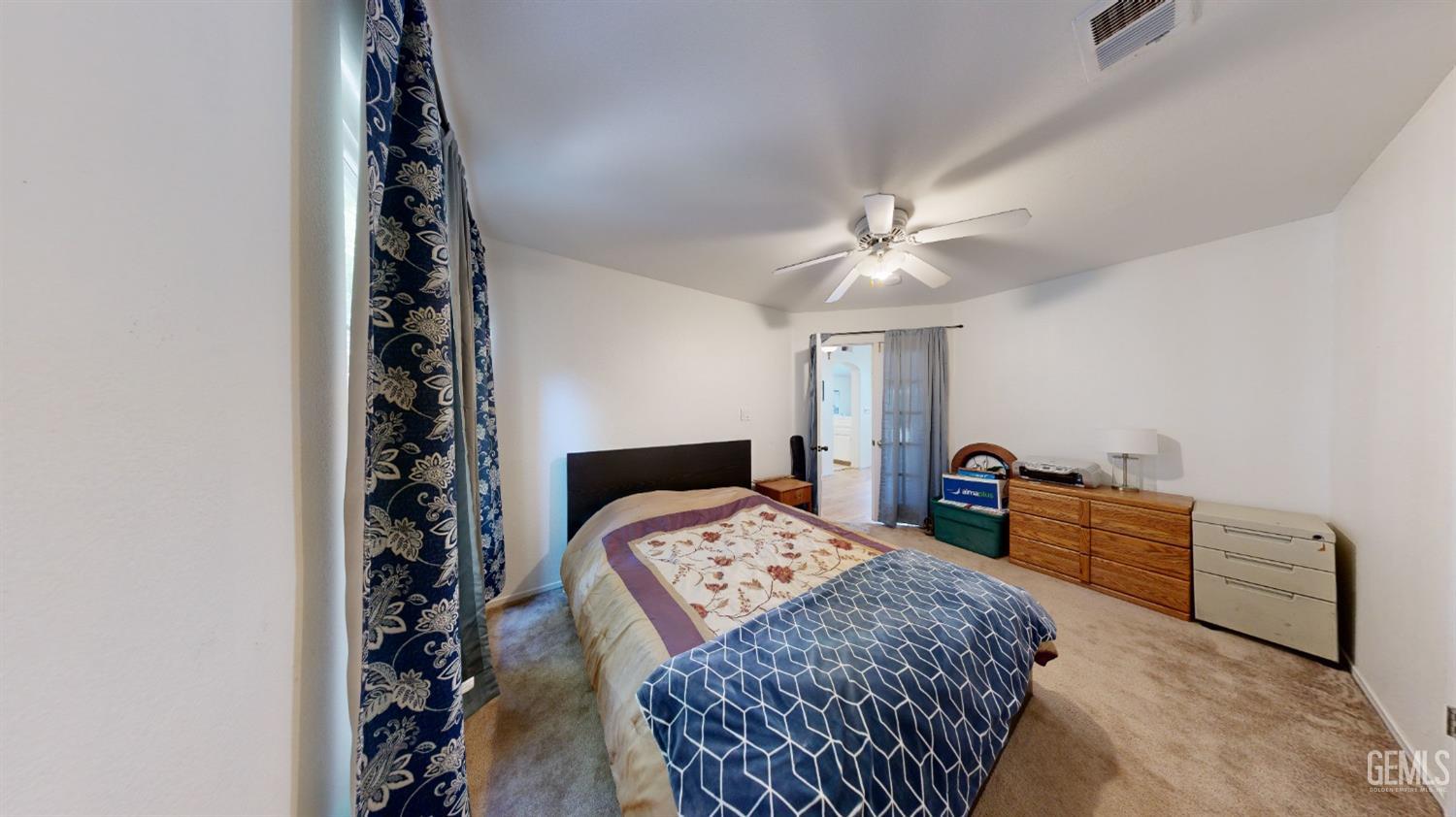 Undisclosed Address Bakersfield, CA 93313 - Photo 14 of 37 a bedroom with a bed and a chandelier