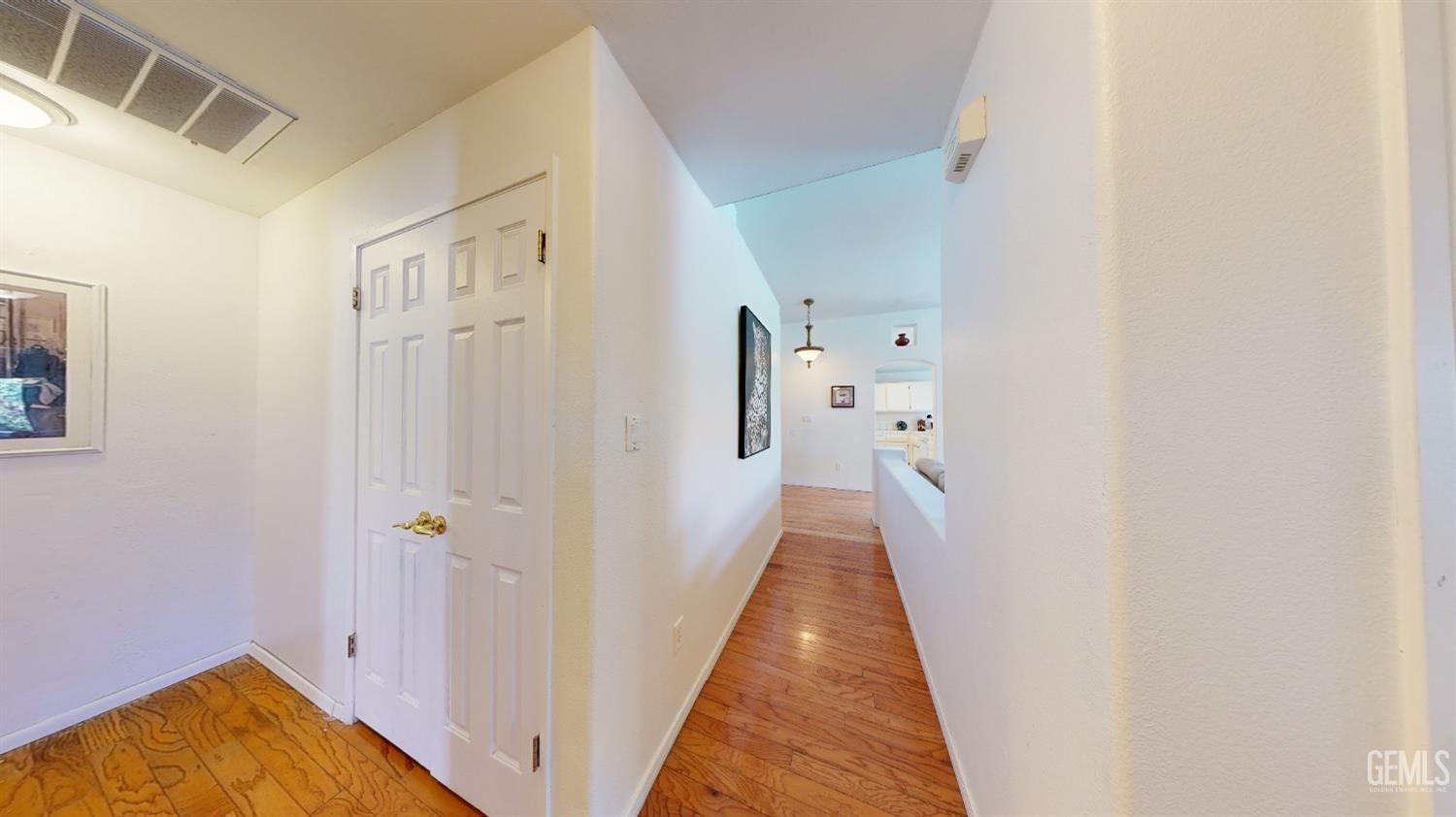 Undisclosed Address Bakersfield, CA 93313 - Photo 16 of 37 a view of a hallway with wooden floor and a bathroom