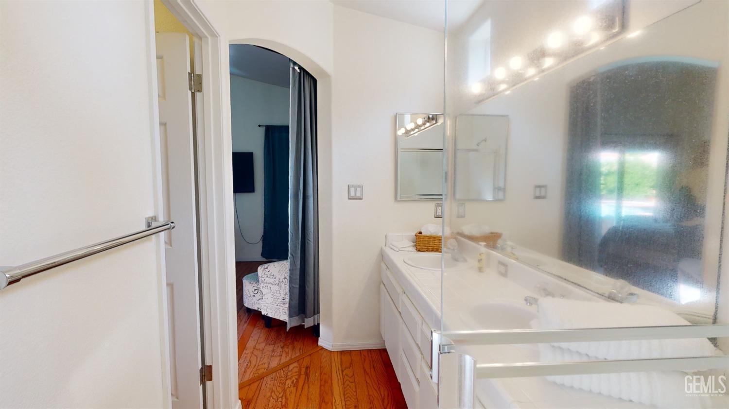 Undisclosed Address Bakersfield, CA 93313 - Photo 23 of 37 a bathroom with a sink and a mirror