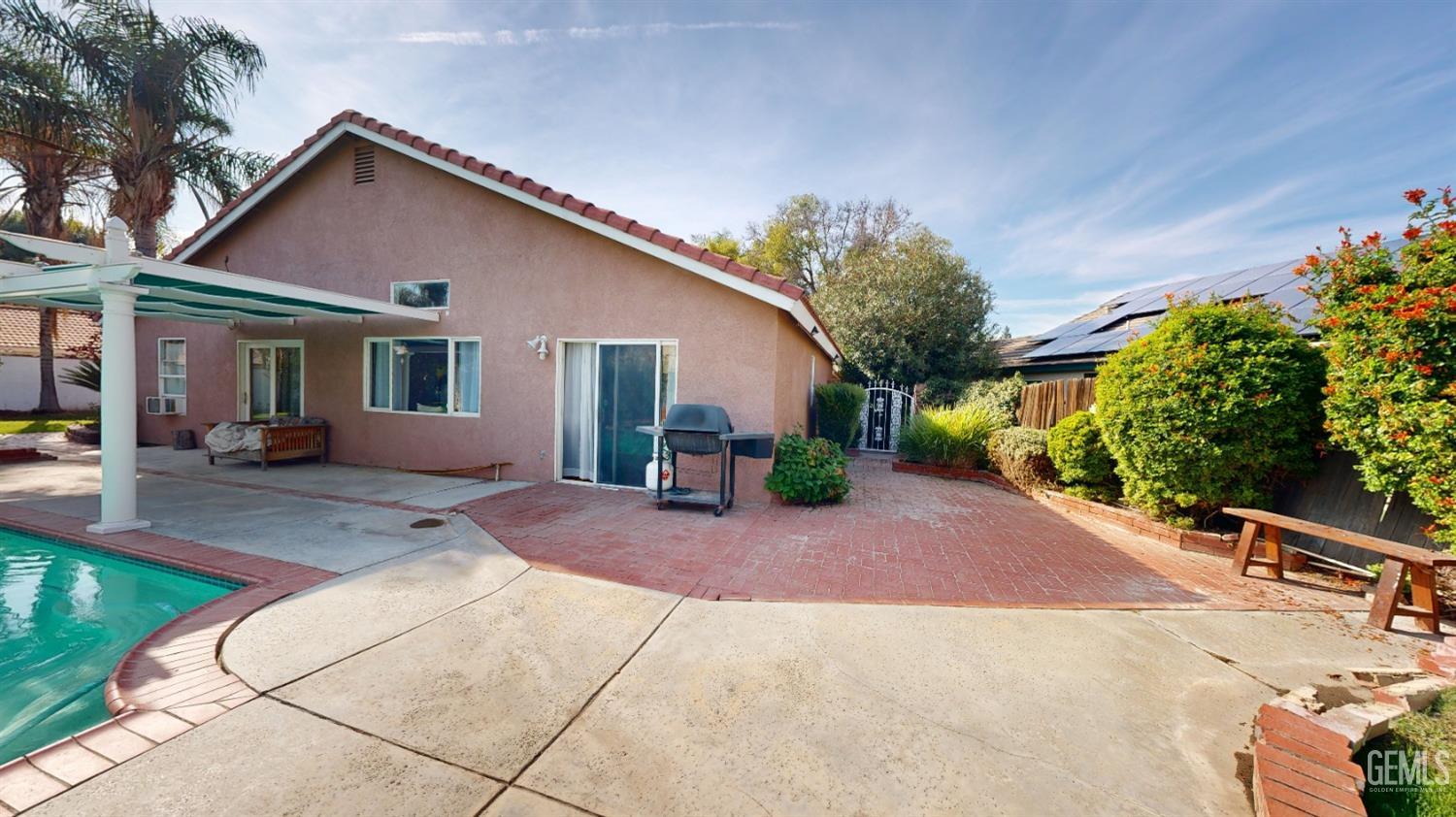Undisclosed Address Bakersfield, CA 93313 - Photo 29 of 37 a front view of a house with a yard and potted plants