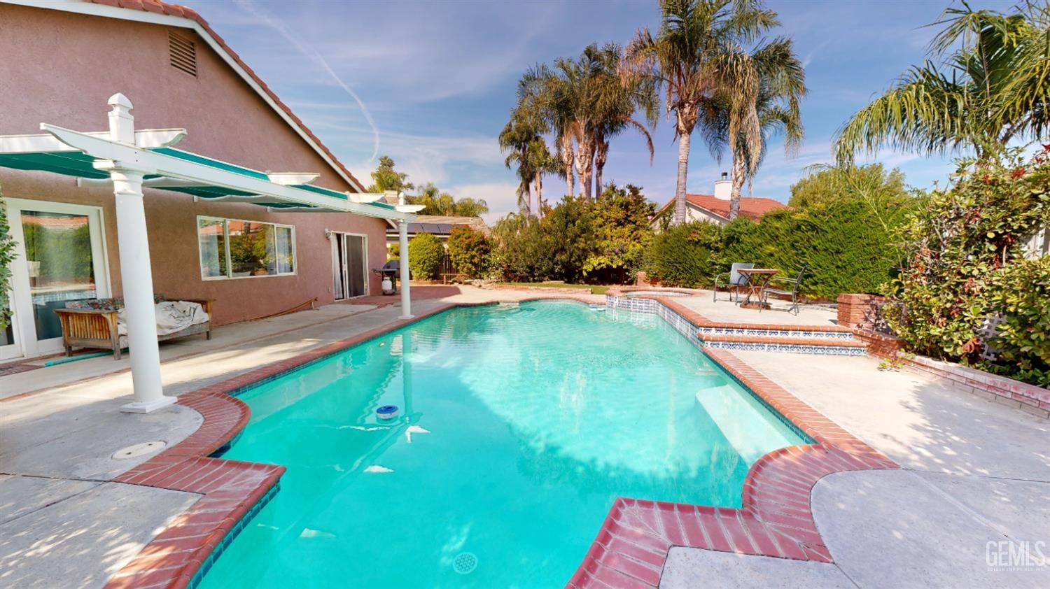 Undisclosed Address Bakersfield, CA 93313 - Photo 31 of 37 a swimming pool with outdoor seating and yard