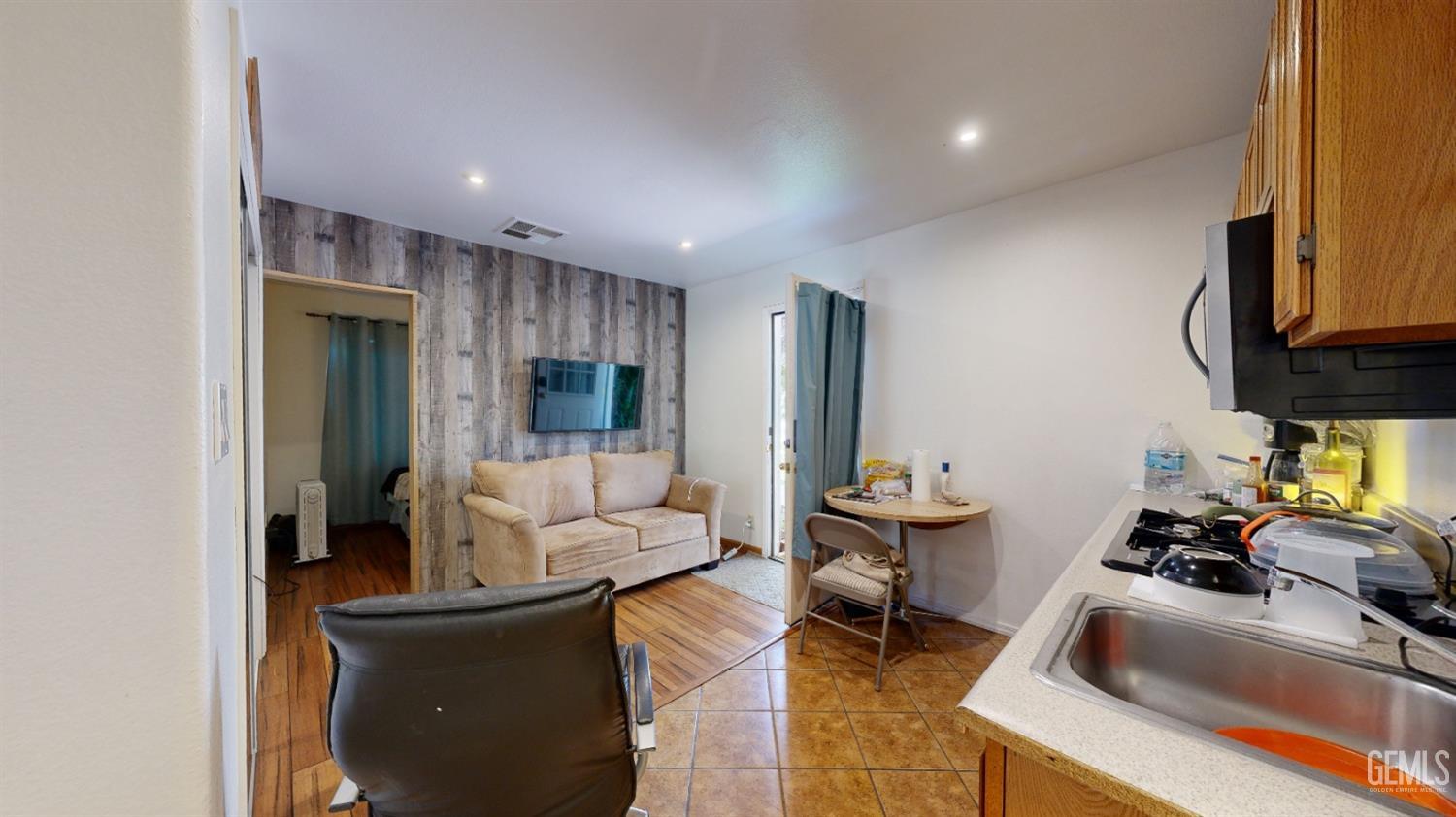 Undisclosed Address Bakersfield, CA 93313 - Photo 35 of 37 a living room with furniture and a flat screen tv