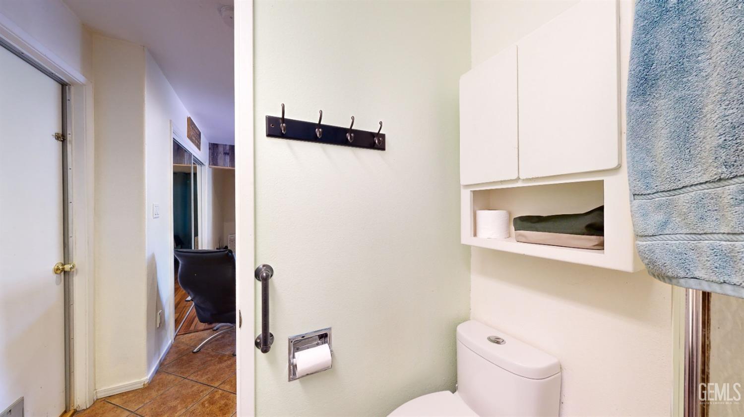 Undisclosed Address Bakersfield, CA 93313 - Photo 37 of 37 a bathroom with a toilet and a shower