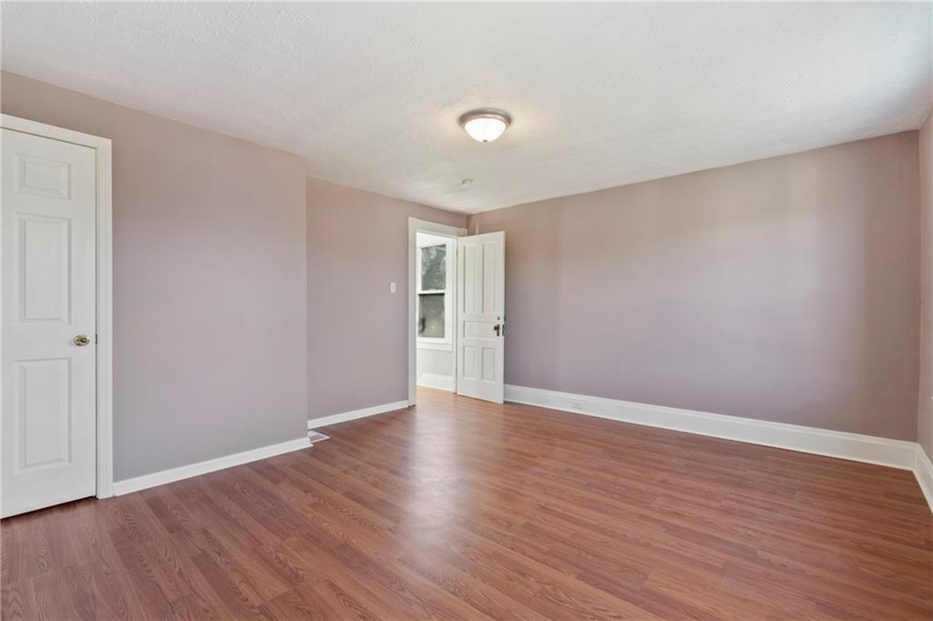 711 9th Avenue Irwin, PA 15642 - Photo 19 of 26 a view of an empty room with wooden floor and closet