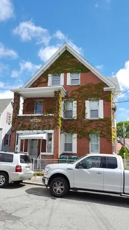 a front view of a house with parking space