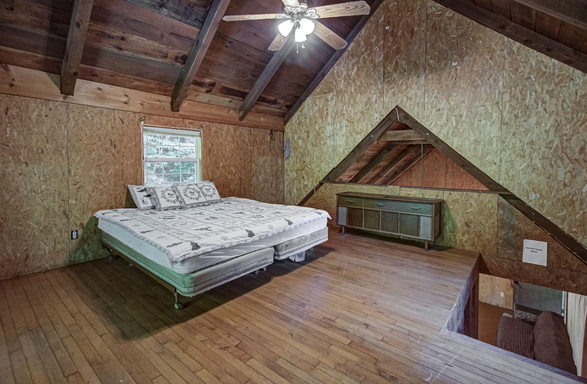 230 Big Towee Road Reliance, TN 37369 - Photo 15 of 69 a bedroom with a bed a table and wooden floor