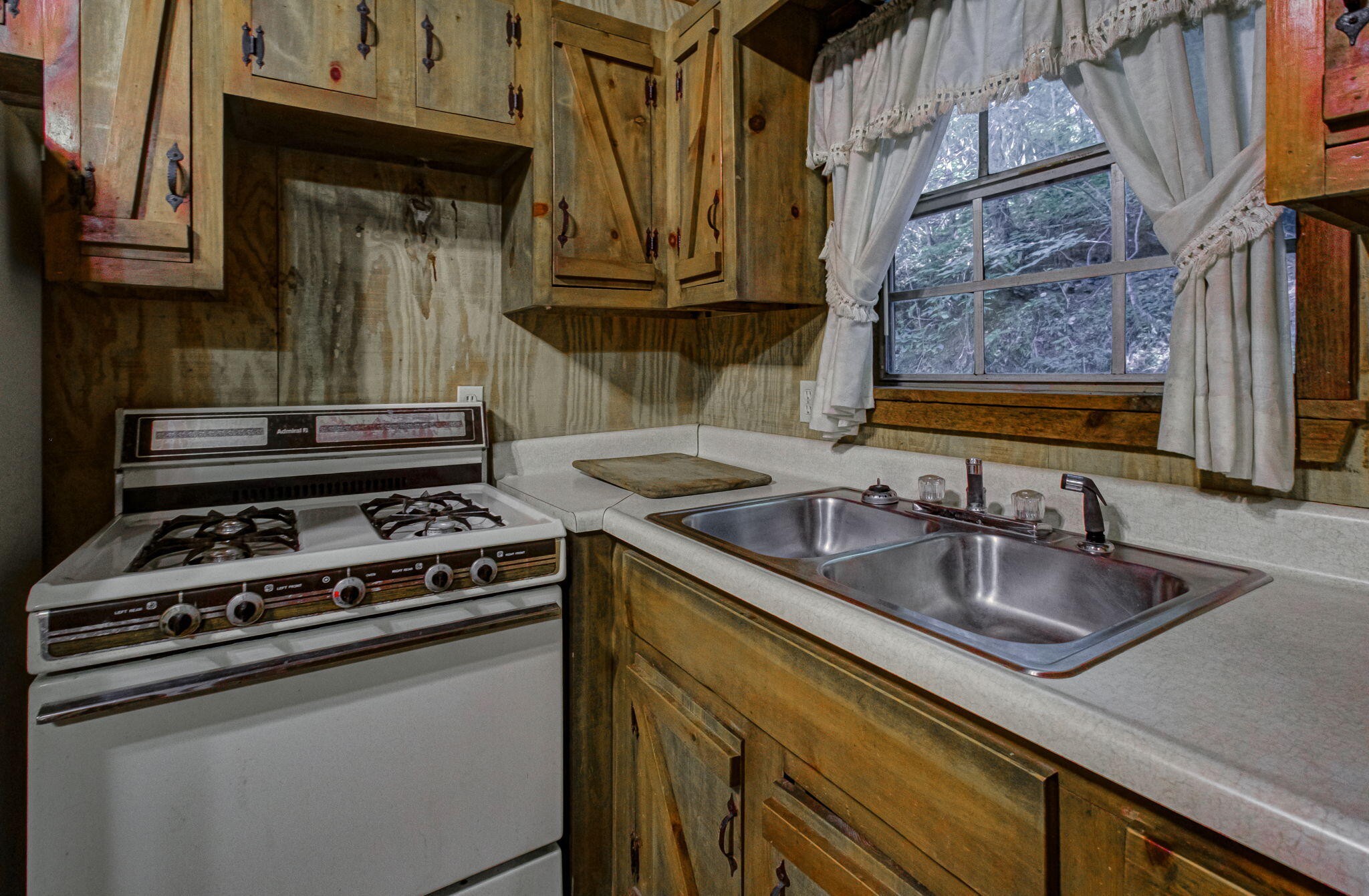 230 Big Towee Road Reliance, TN 37369 - Photo 4 of 69 a kitchen with granite countertop a sink stove and cabinets