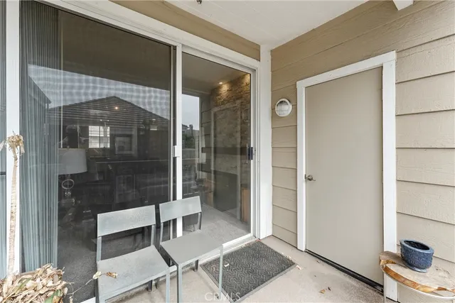 a living room with a walk in closet and a glass door shower