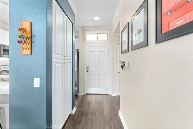 a view of a hallway with wooden floor