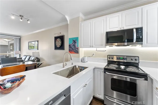 a kitchen with a sink stove and microwave