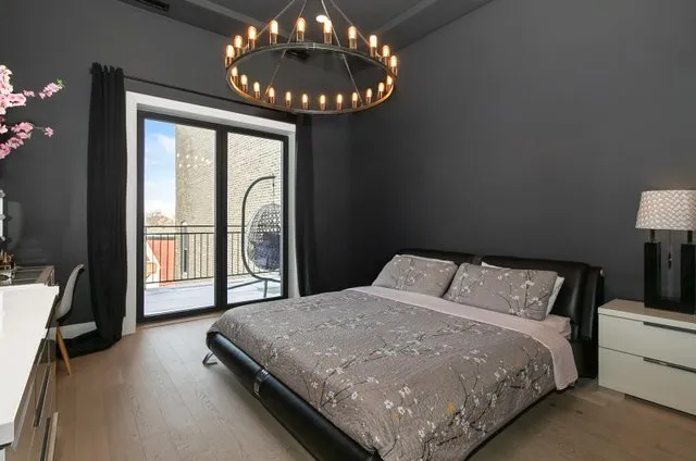 a bedroom with a large bed and a large window