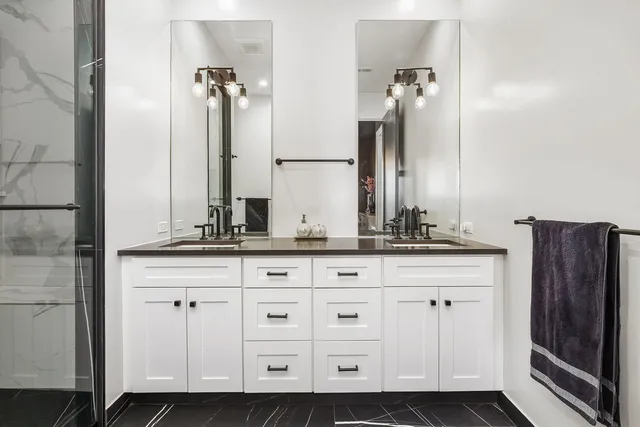 a bathroom with a double vanity sink and a mirror