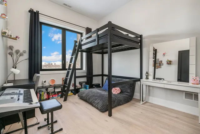 a bedroom with furniture and a window