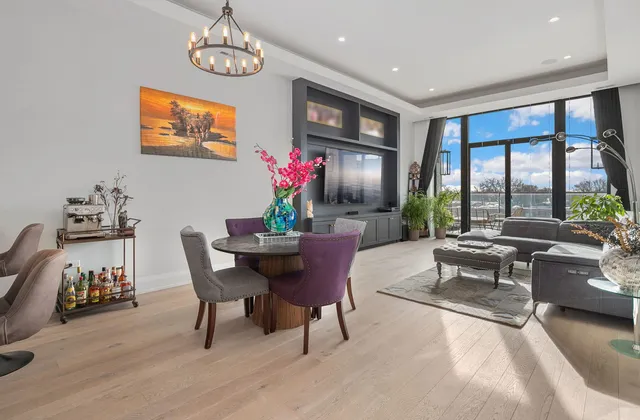 a dining room with furniture a window and a chandelier