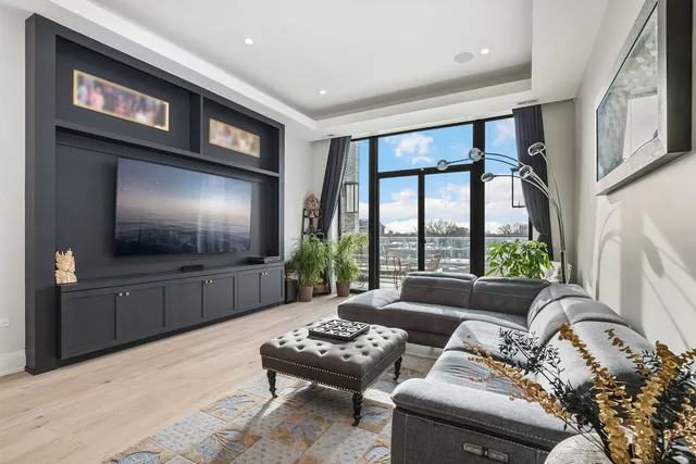 a living room with furniture a large window and a flat screen tv