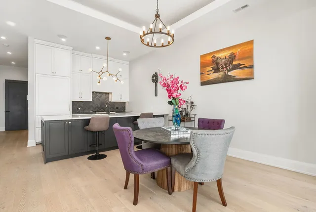 a view of a dining room with furniture and a chandelier