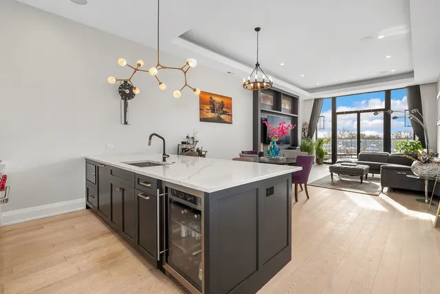 a view of living room kitchen island furniture and a chandelier