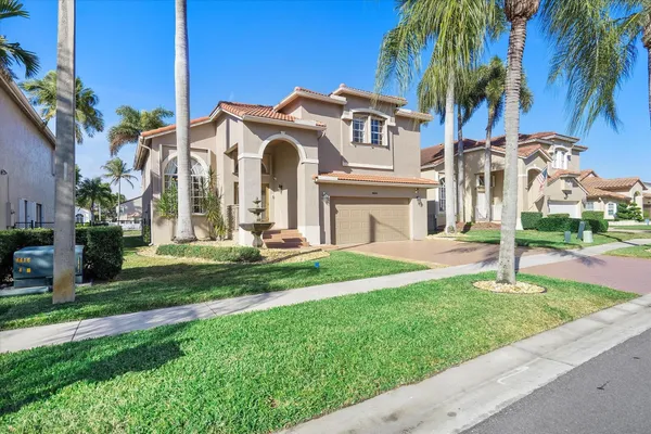 a front view of a house with a yard