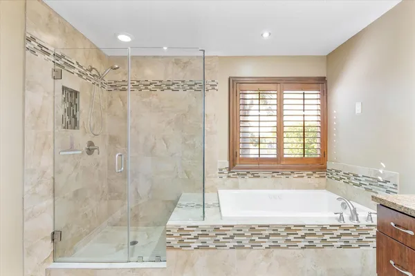 a bathroom with a bathtub and a shower