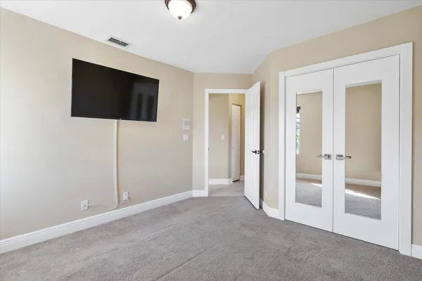 a view of a livingroom with an empty space and a flat screen tv