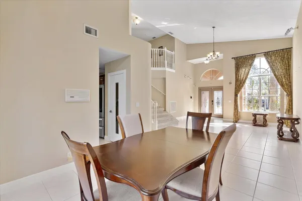 a view of a a dining room with furniture window and wooden floor