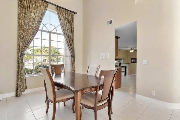 a view of a dining room with furniture and a window