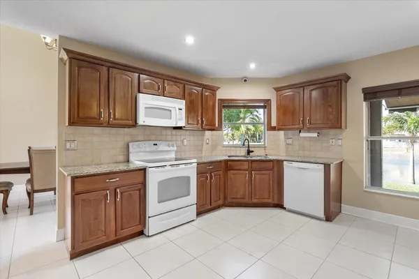 a kitchen with a stove top oven sink and cabinets