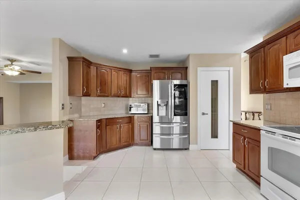 a large kitchen with cabinets and stainless steel appliances