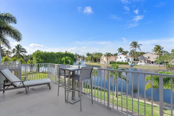 a view of roof deck with chair and table