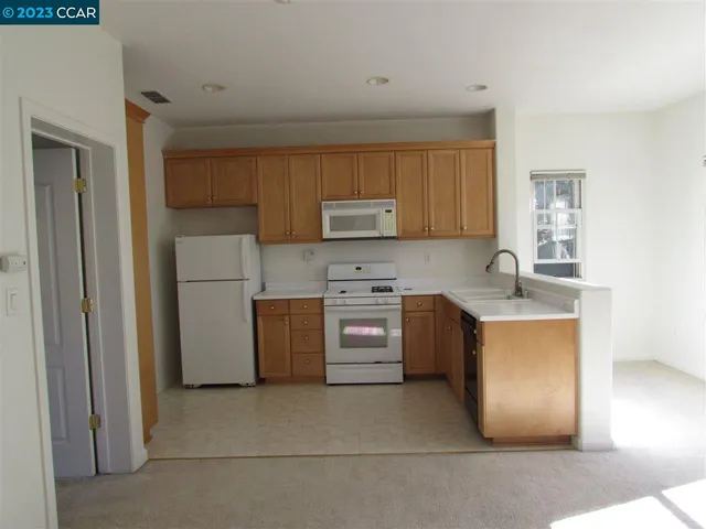 a kitchen with a stove a sink and a refrigerator