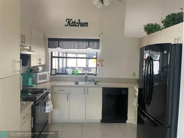 a kitchen with a sink stove and refrigerator