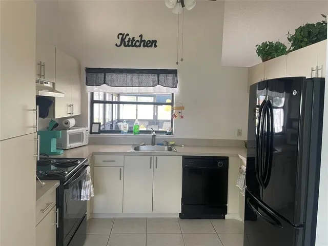 a kitchen with a sink stove and refrigerator