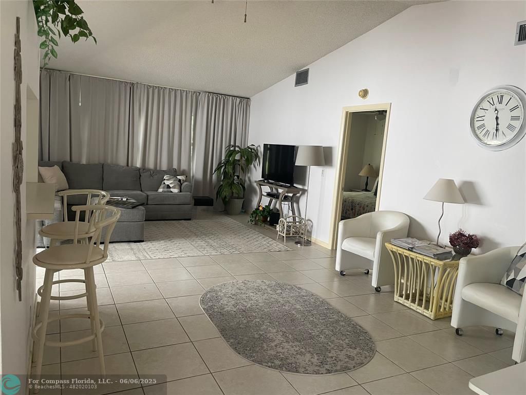 5675 Northpointe Lane Boynton Beach, FL 33437 - Photo 5 of 8 a living room with furniture and a flat screen tv