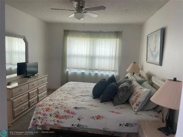 a bedroom with a bed and a television