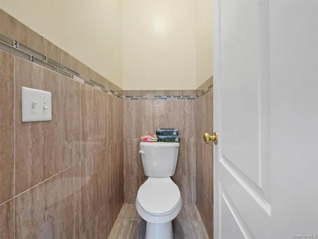 a bathroom with a toilet and a shower curtain