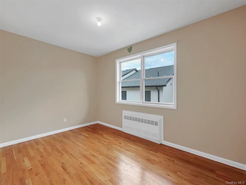 480 West Central Avenue Spring Valley, NY 10977 - Photo 24 of 35 a view of an empty room with wooden floor and a window