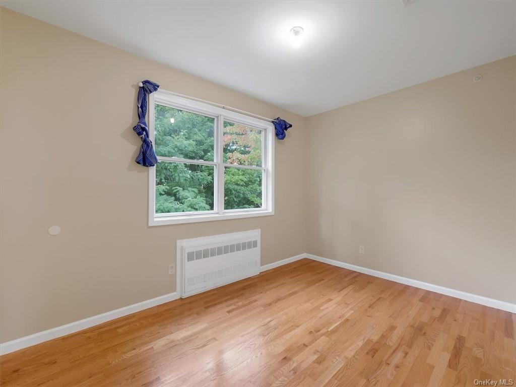 480 West Central Avenue Spring Valley, NY 10977 - Photo 26 of 35 an empty room with wooden floor and windows