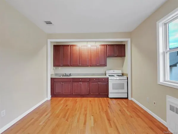a kitchen with granite countertop a stove and cabinets